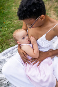 black mother breastfeeding daughter