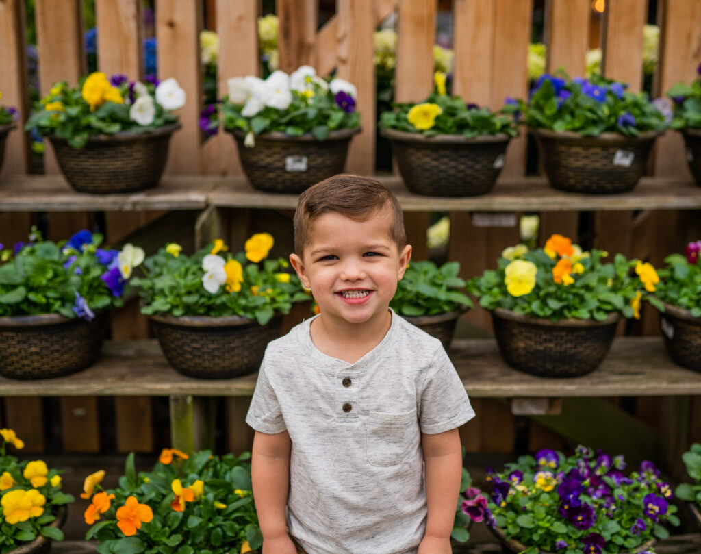 little boy smiling by the flowers in a north royalton ohio store
