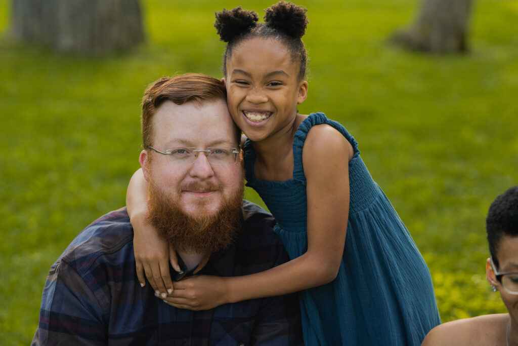 daughter hugging father as they both smile at the camera in cleveland ohio